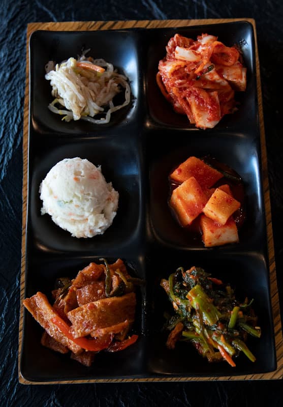 Fresh banchan tray with kimchi, pickles, and side dishes